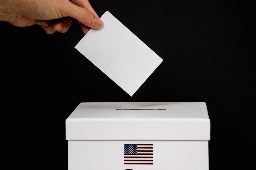 photo of person dropping a vote