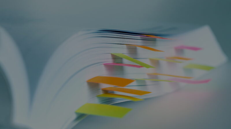 Close up White book marked by sticky note