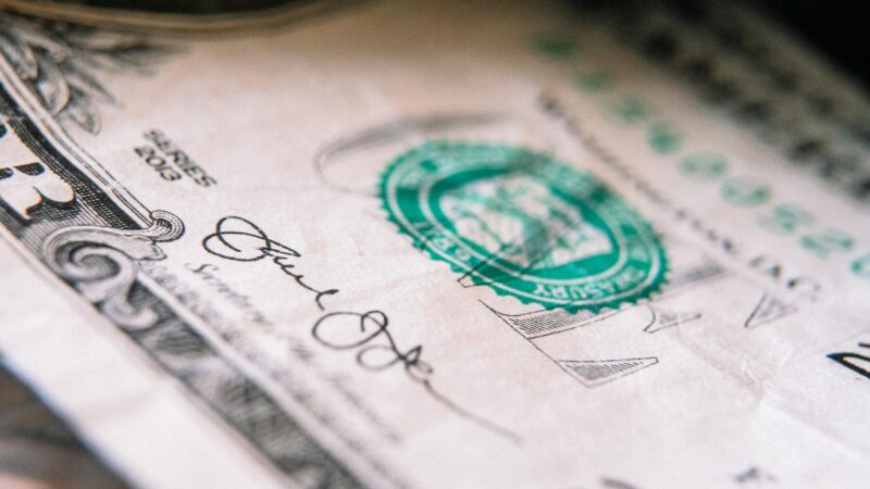 one us dollar banknote on table