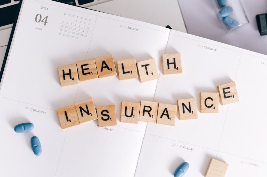 health insurance scrabble tiles on planner