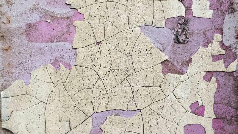 close up of cracked peeling paint on wall