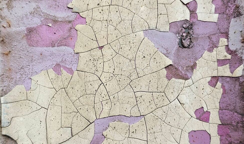 close up of cracked peeling paint on wall